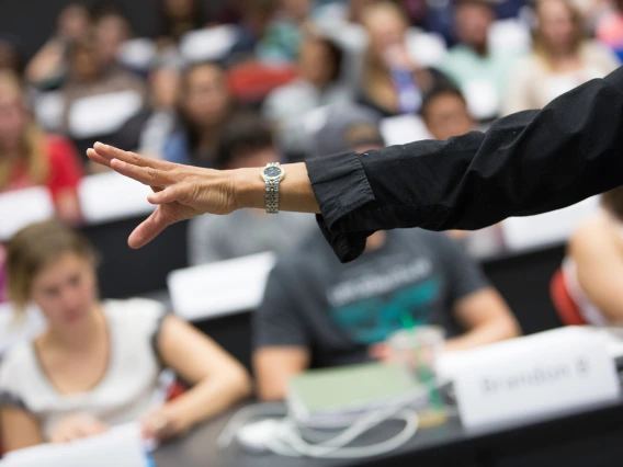 Image of a teacher gesturing during a lecture